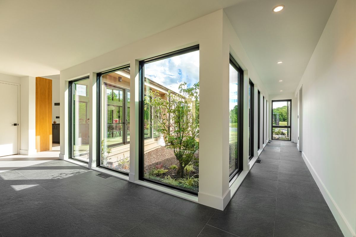 At the entrance is a hallway leading to the Master suite. The living room can be seen through the glass walls.