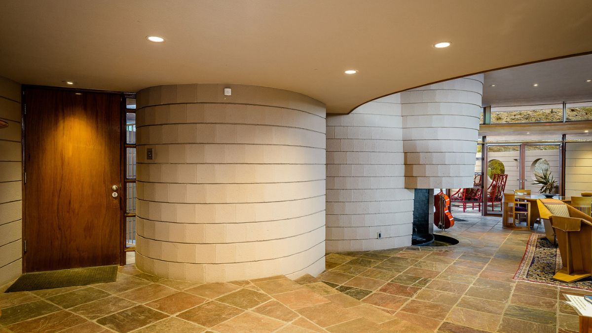 The inner view of the wooden front door, which leads directly to the living room.