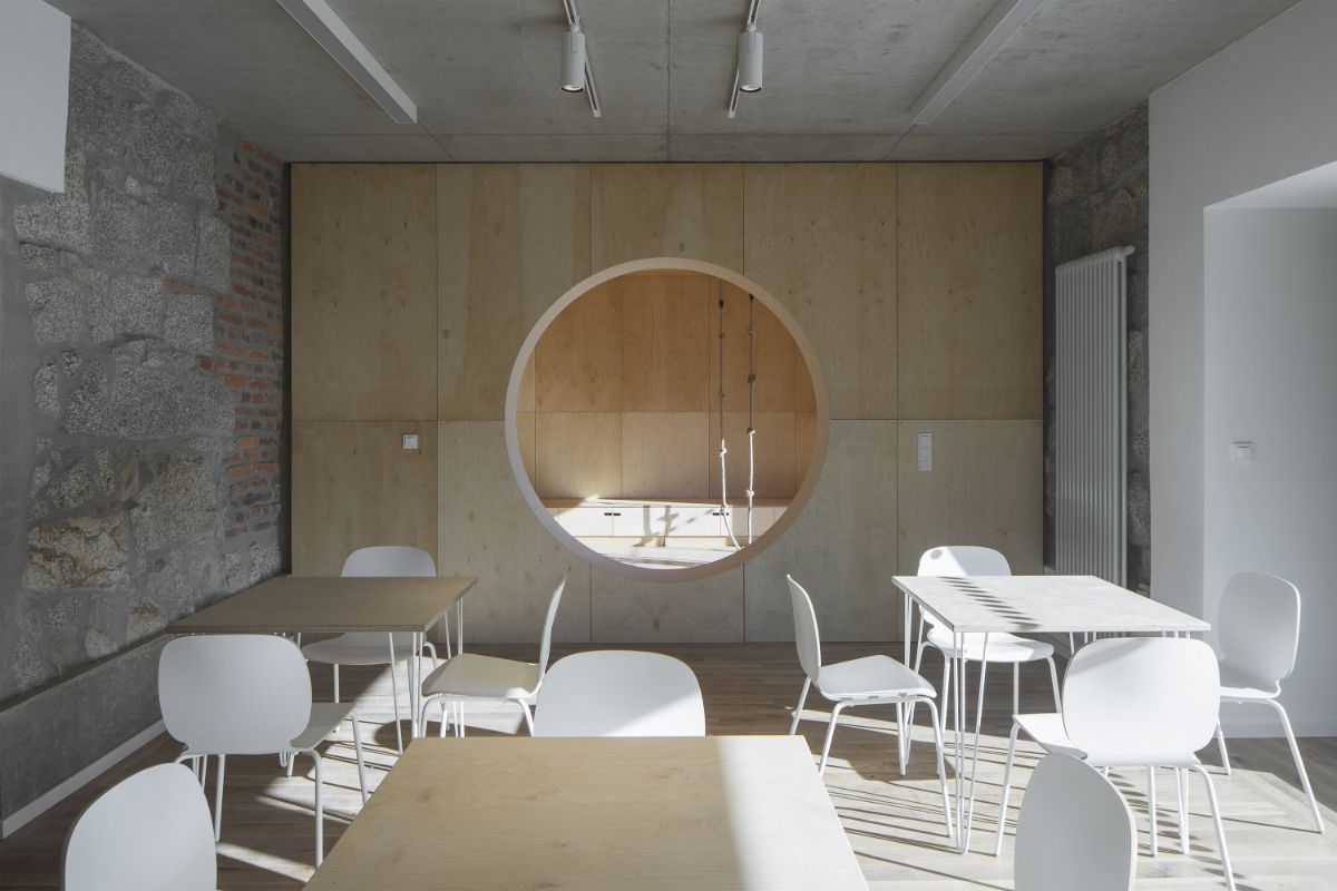 The reading area with exposed concrete and the brick and stone masonry.