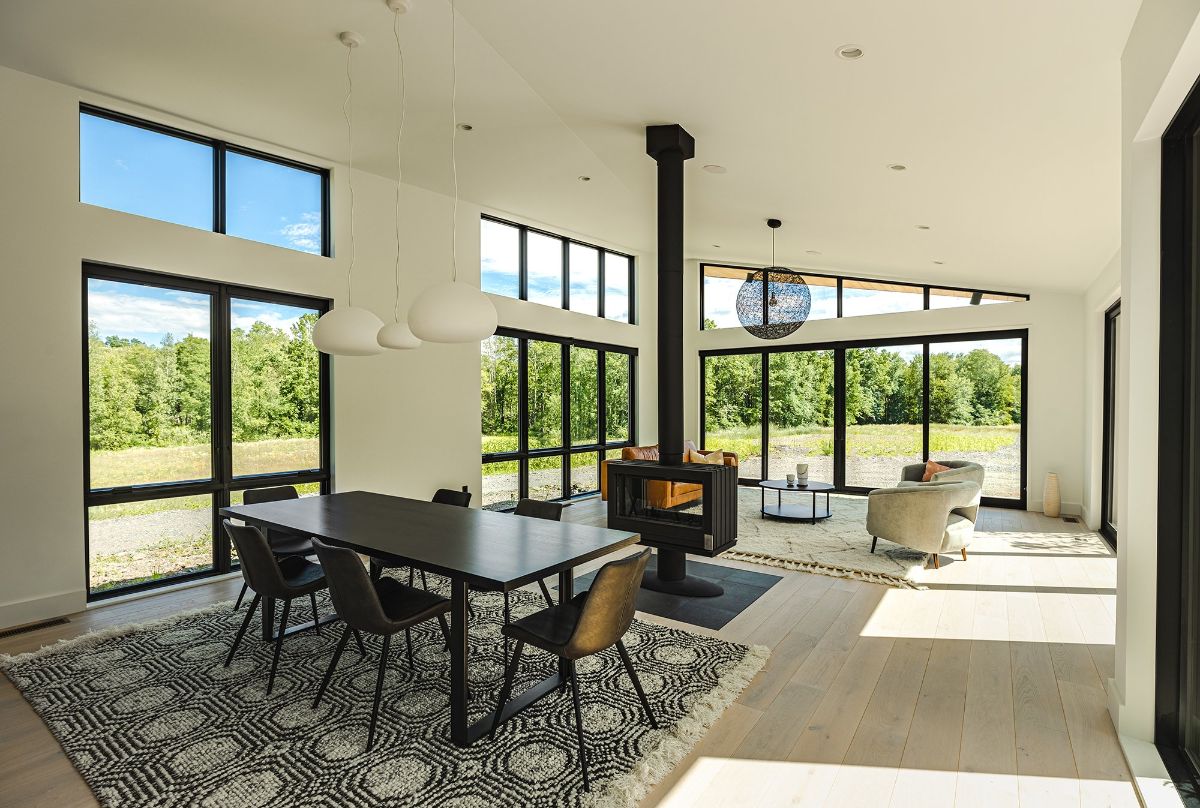 A wood-burning stove fireplace between the living room and the dining area warms the place.