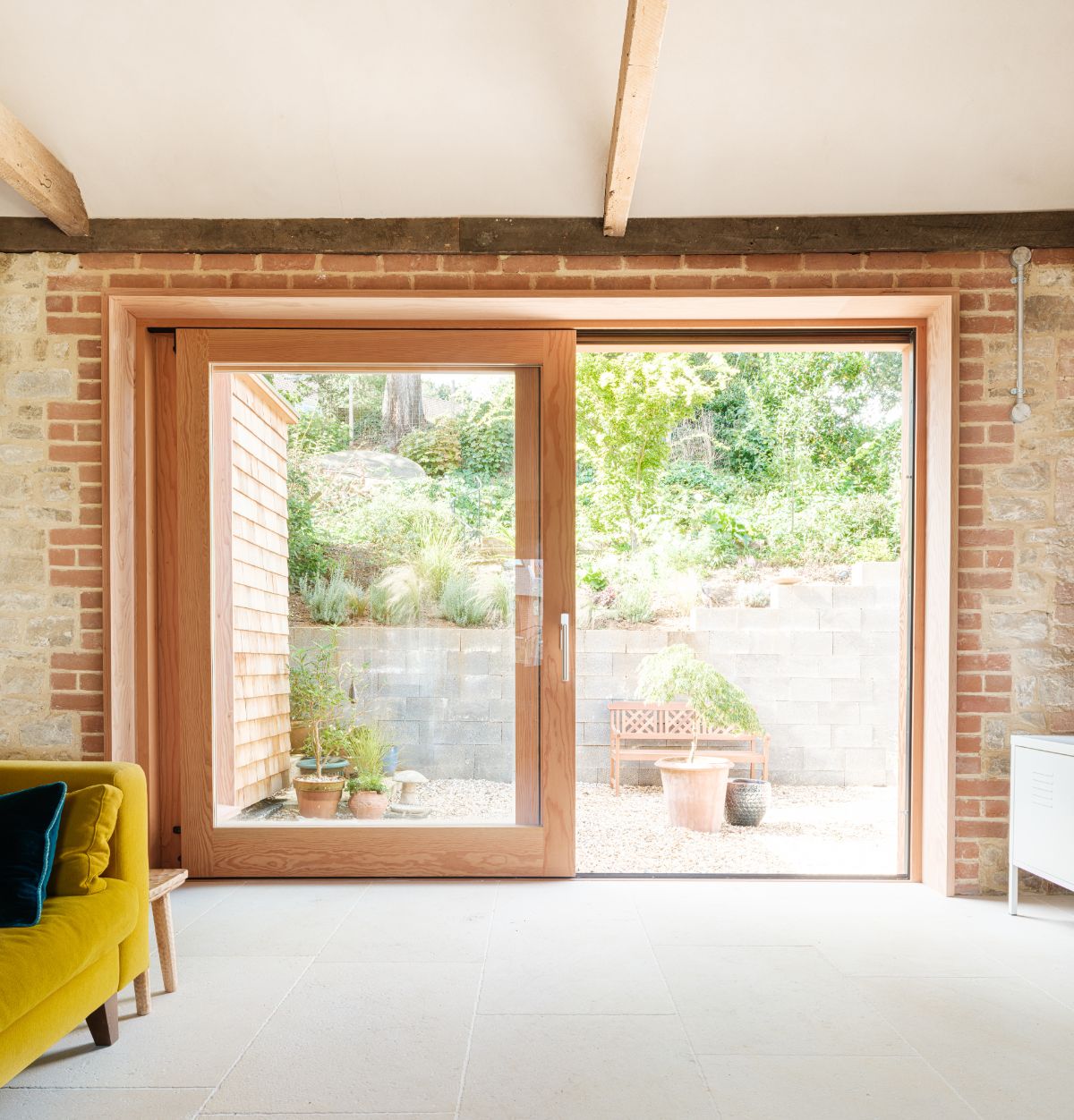 The entrance has a full glass door with wooden frames leading to the living room.