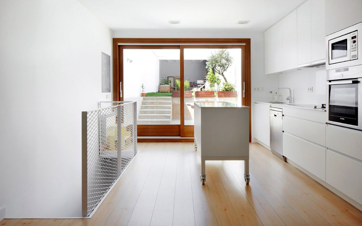 This picture shows the kitchen connected to the backyard and the existing pantry-storeroom.