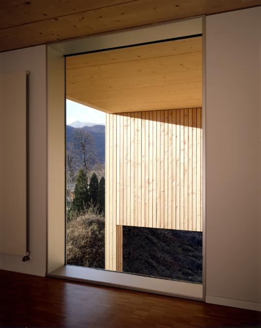 An interior shot of a full height window showing the view outside