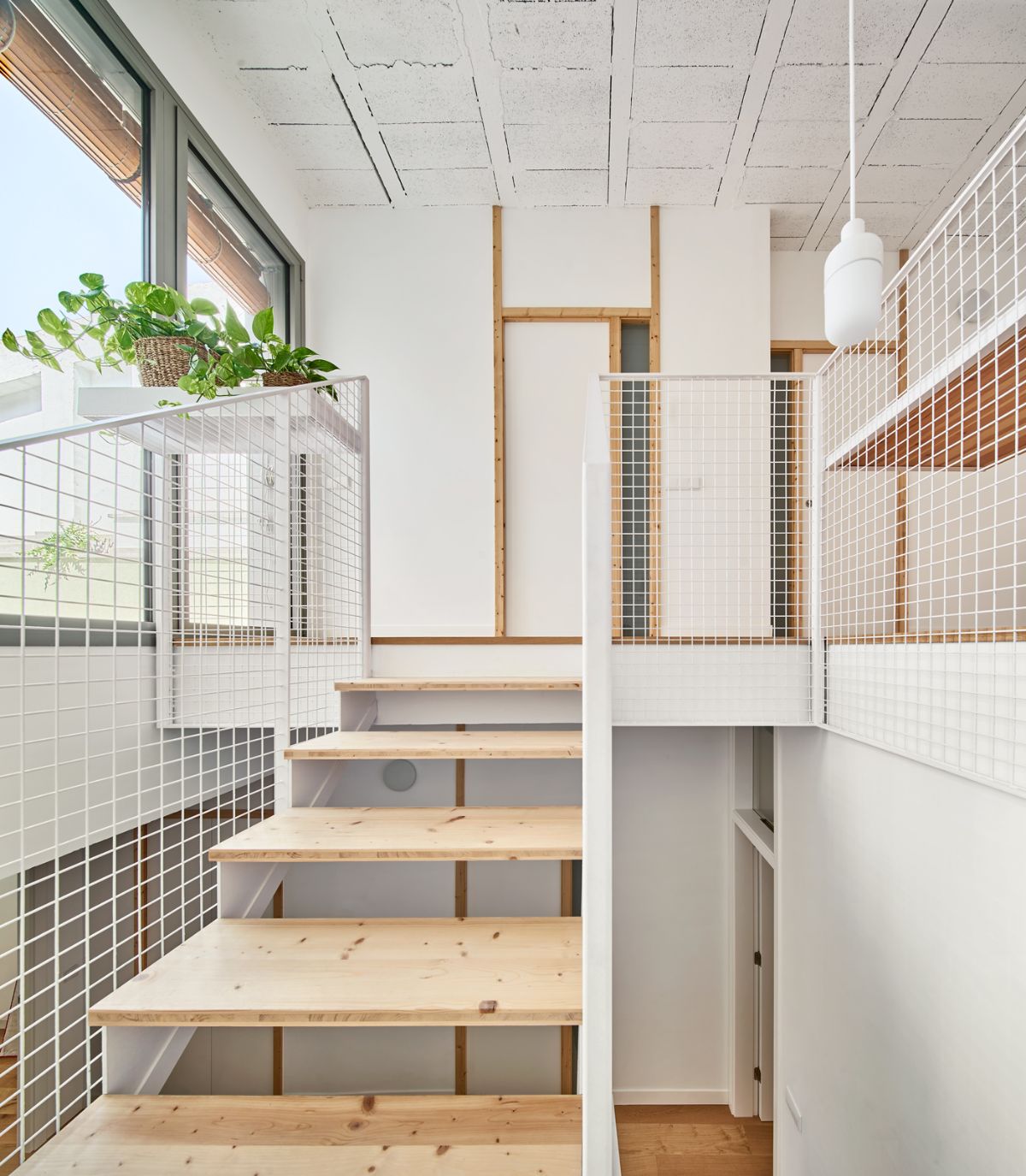 The stairs reach up to the top floor and are designed with wood.