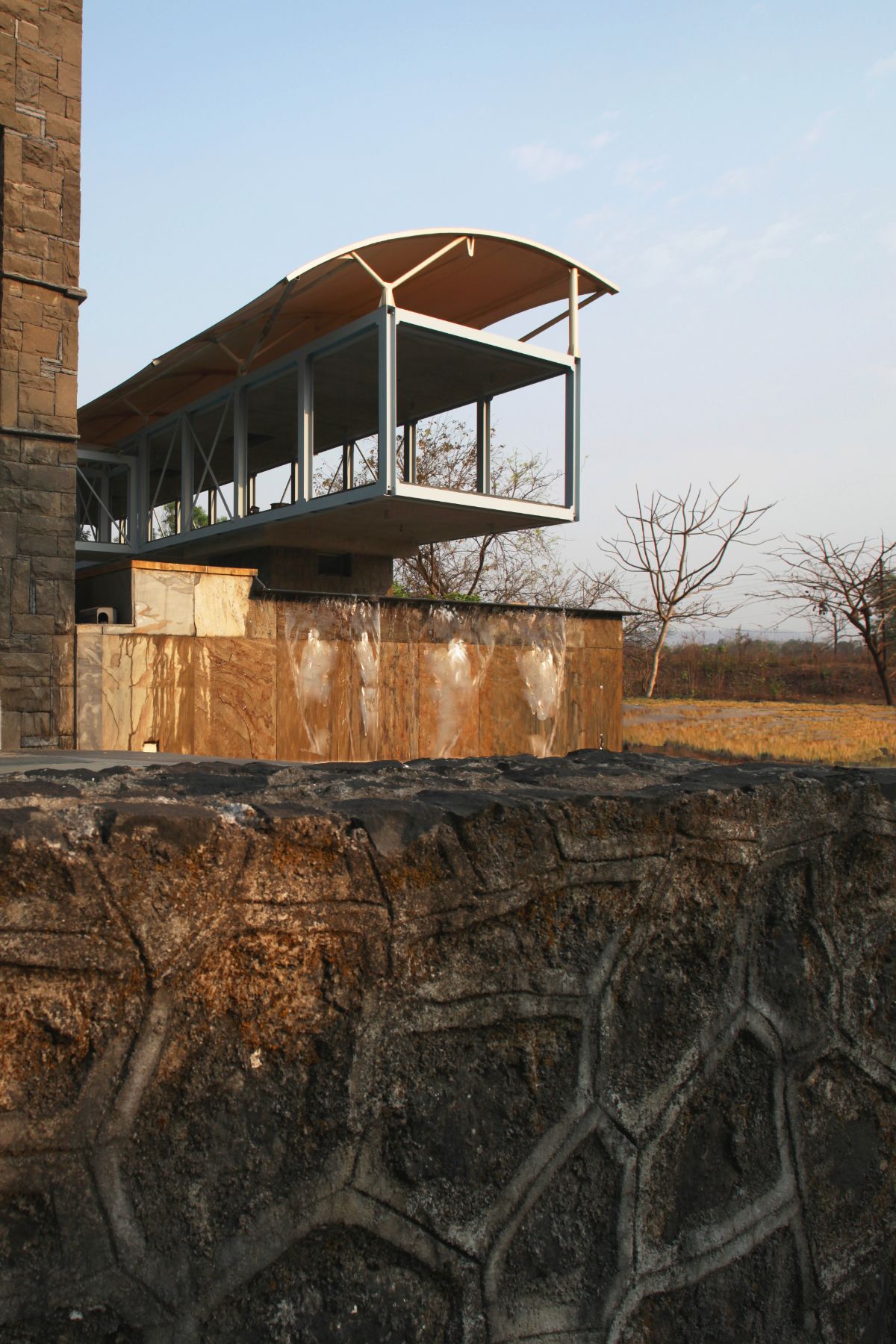 The floating block lifted about the ground has an open kitchen and a living space.