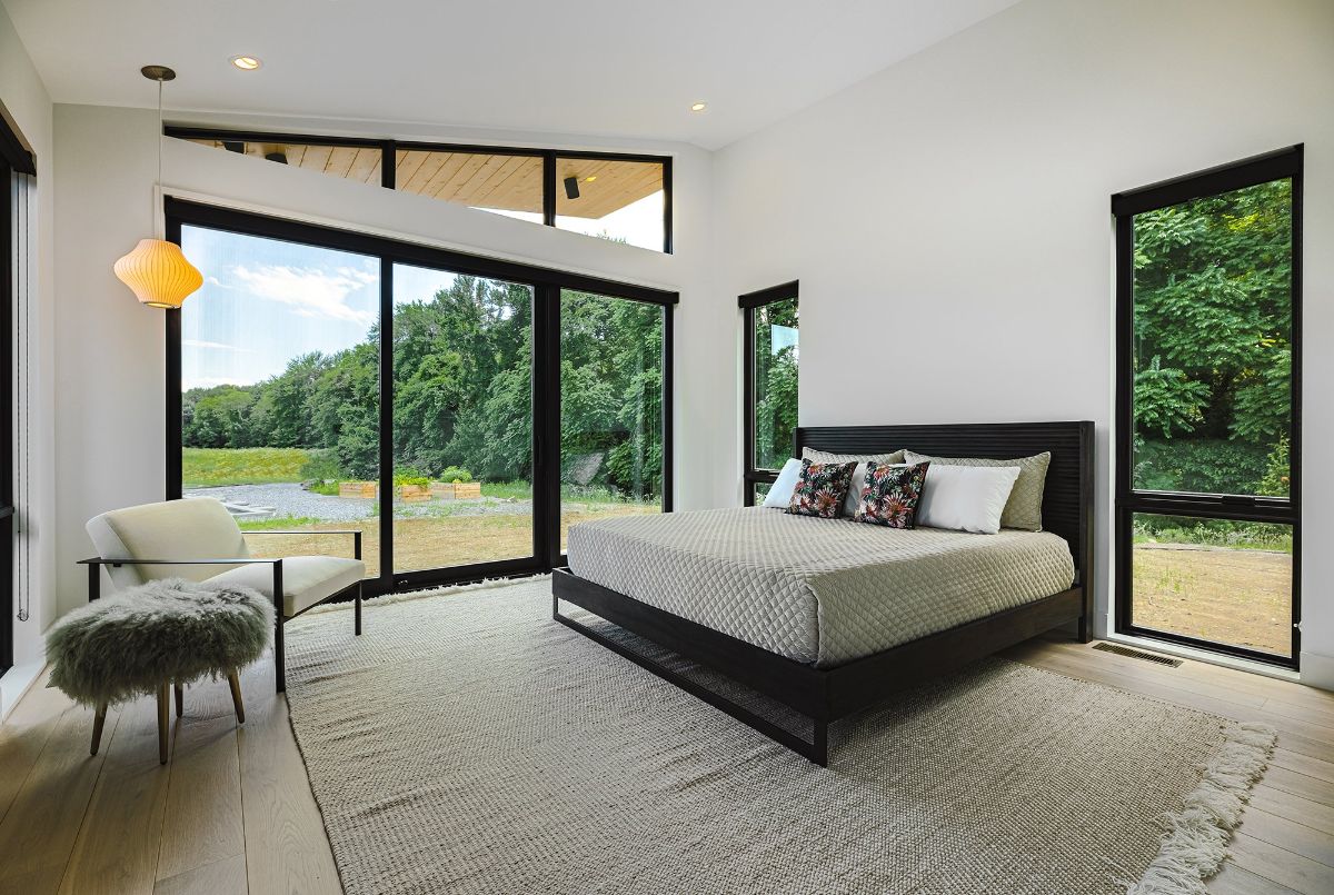 The master suite has full-size glass doors to access the backyard and the scenery outside.