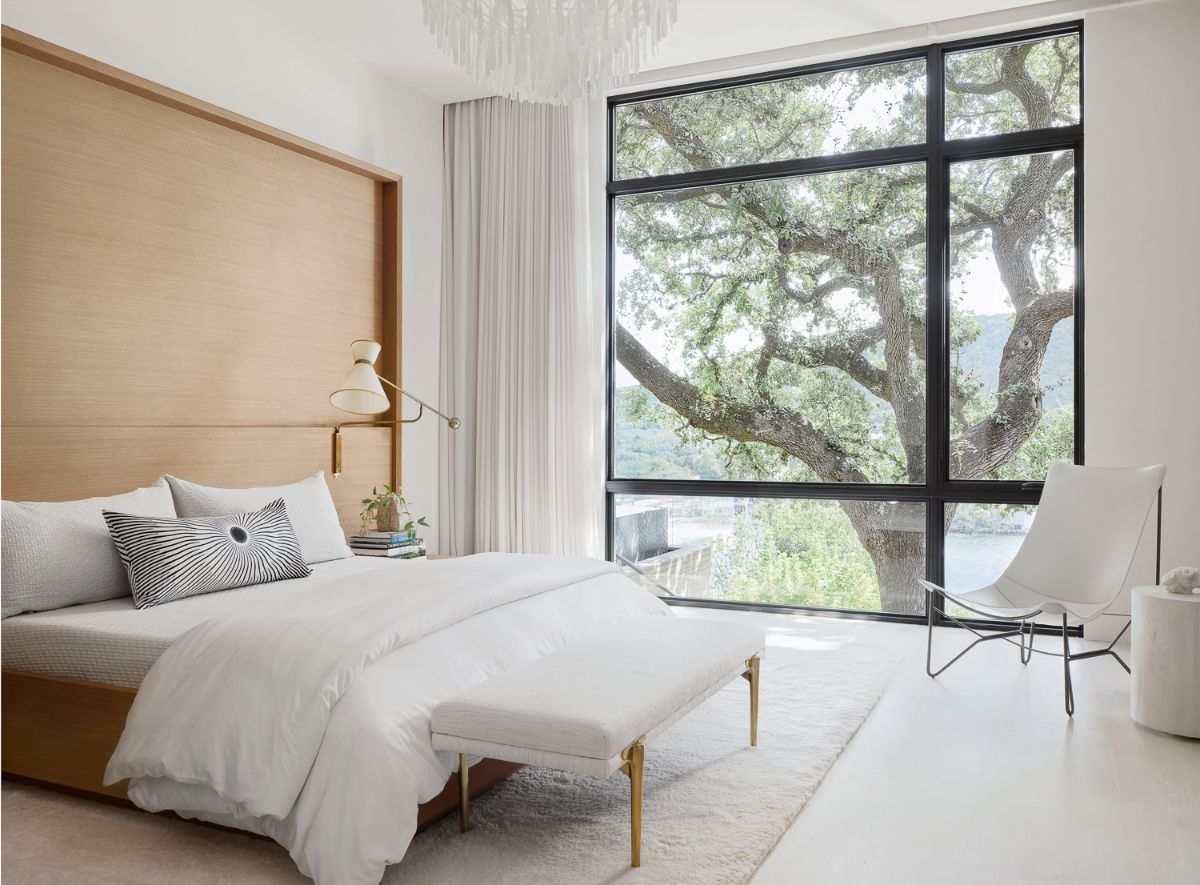 The main suite, which features floor-to-ceiling glass windows with views of the magnificent oak trees.