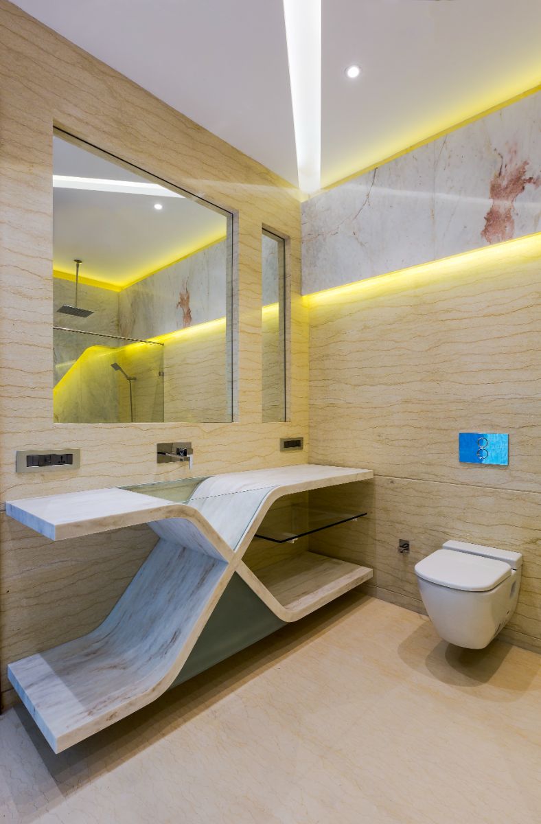 A bathroom with a one-of-a-kind sink design paired with cove lighting.