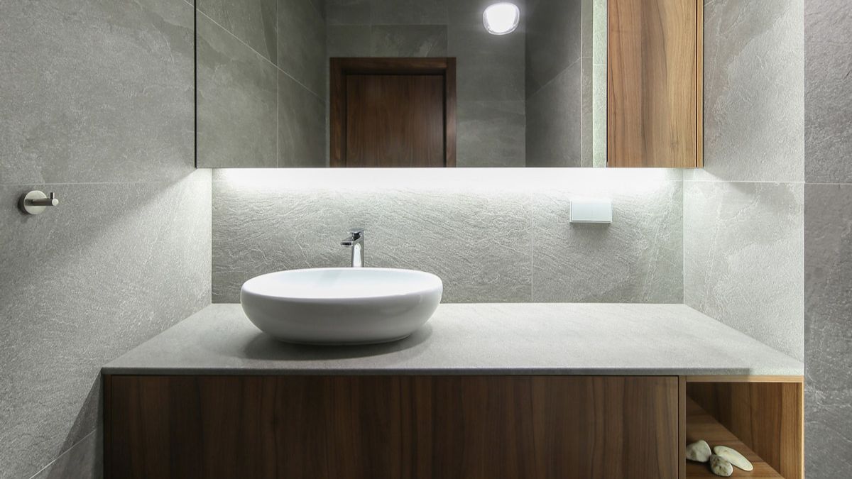 Grey embossed tiles were chosen for the walls of the ground-floor toilet, and the concealed lighting helped to create a serene atmosphere.