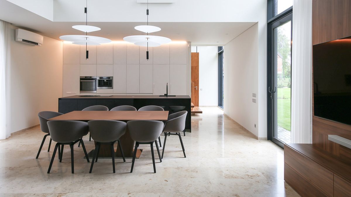 The dining area's high ceilings and abundance of natural light made it the ideal setting for a vibrant, lively color combination that brought out the best of the walnut furniture's color and texture.