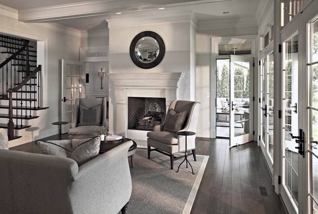 Living room with gray seats, a fireplace, and patio access through glazed doors.