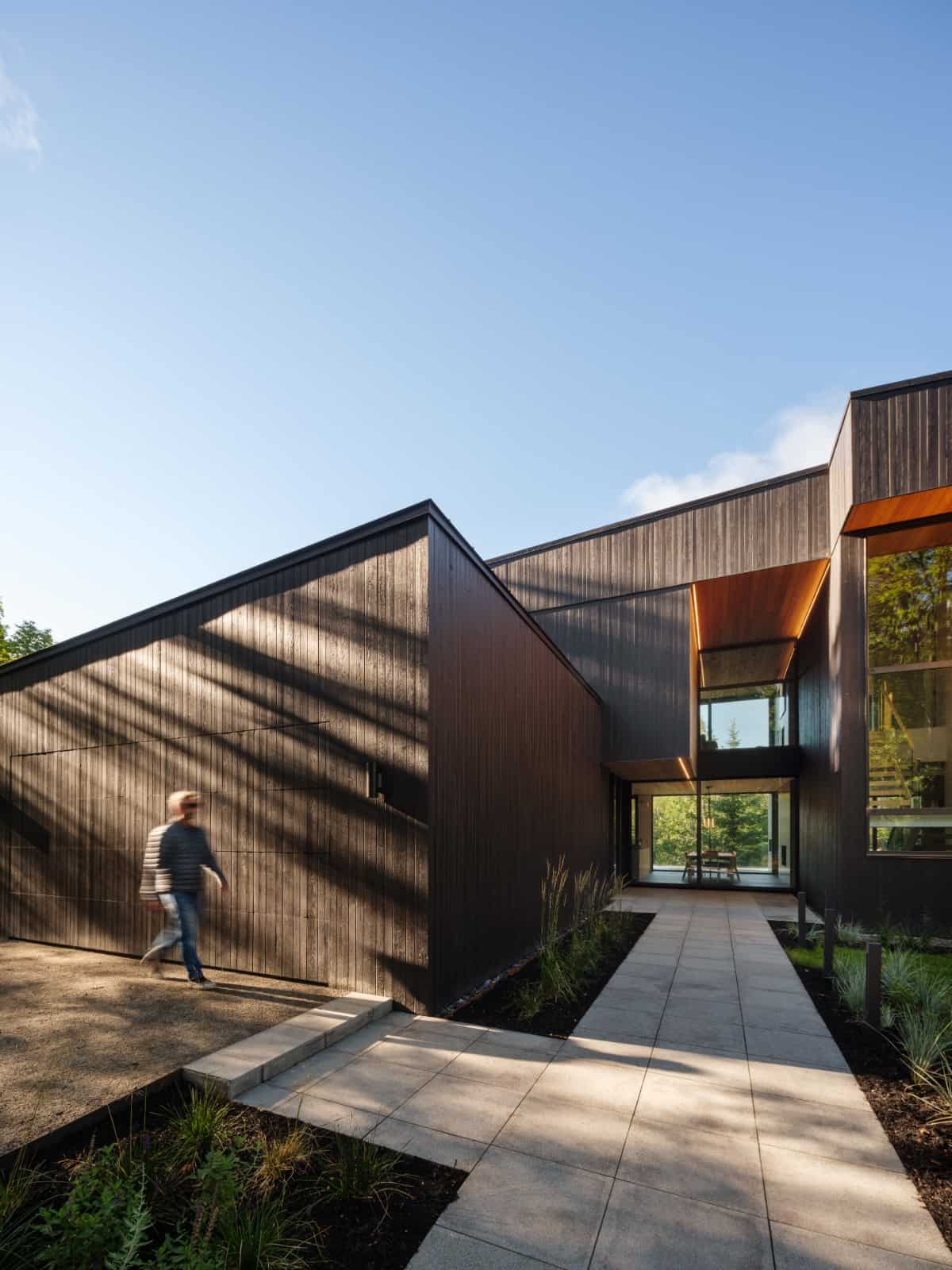 The front-loading garage is complemented by a concrete driveway and a concrete tiled walkway leads to the home's entrance.