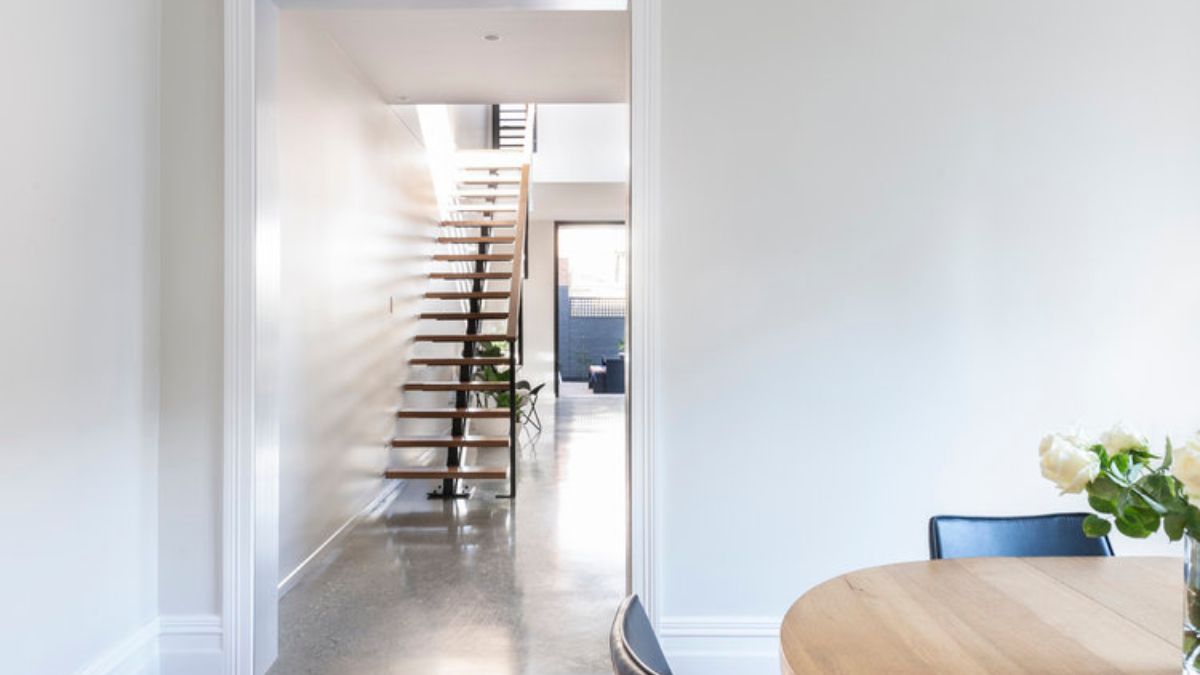 A different angle of the dining area that captures the staircase.