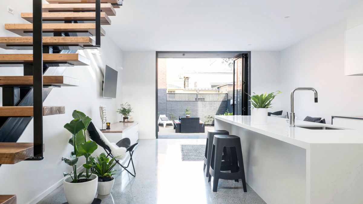 A well-designed kitchen is located next to the staircase.