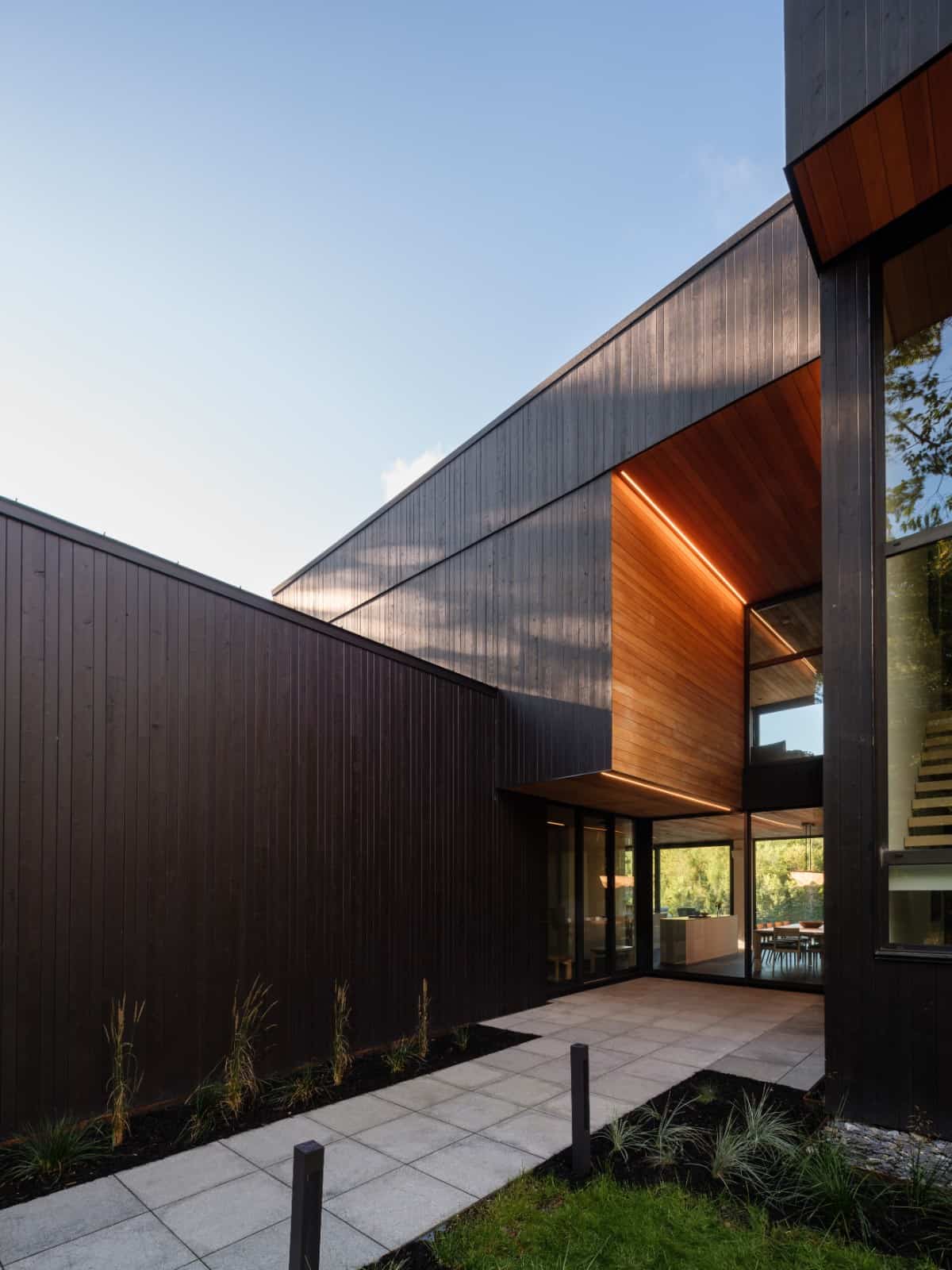 Clean lines from the volumes create a modern look while wood cladding adds warmth to the home's exterior.