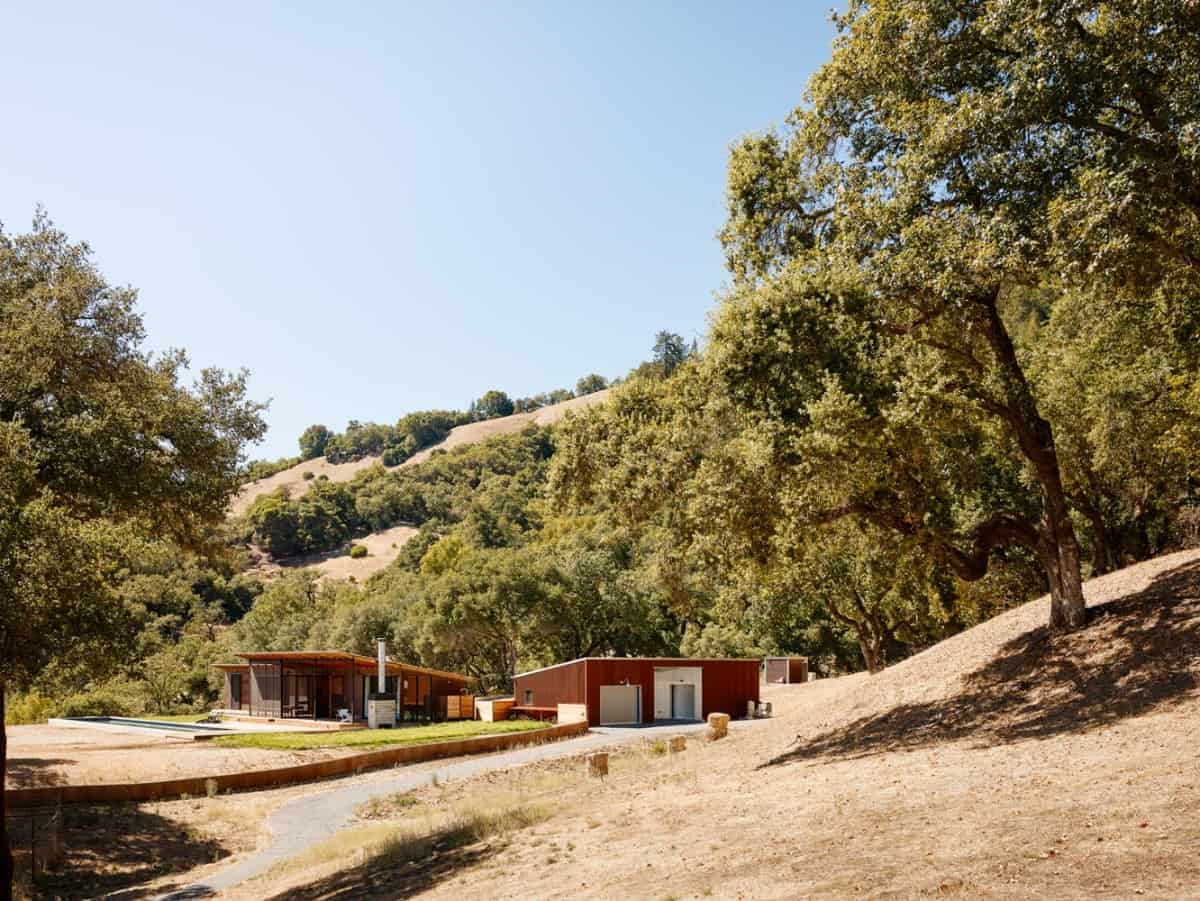 Exterior view of Camp Baird showcasing its car barn and the main pool house.