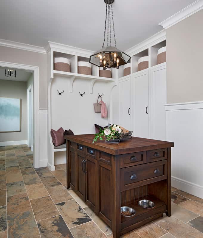 Mudroom with tall cabinets, open shelves, a built-in bench, and a wooden island.