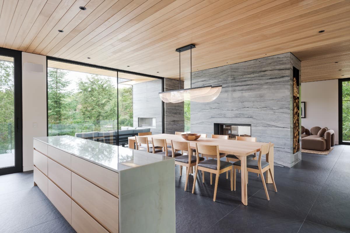 Upon entry, guests are welcomed by a foyer and dining room separated by a large console table.