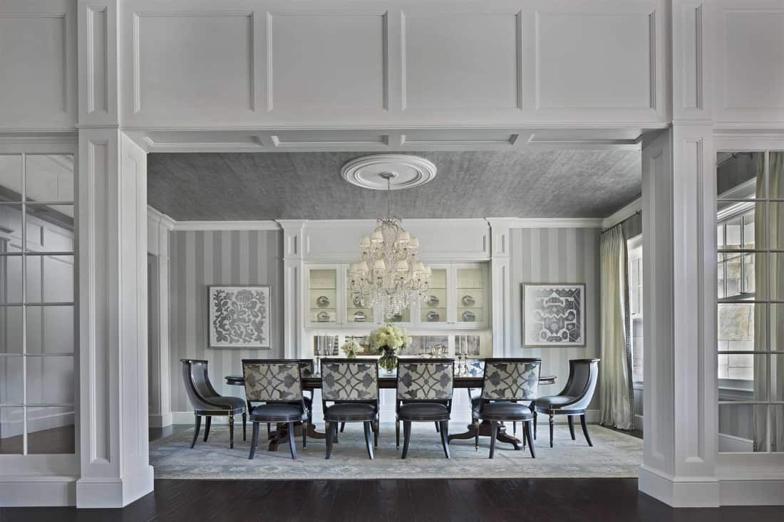 The formal dining room offers a classy 10-seater dining set topped with a crystal chandelier.