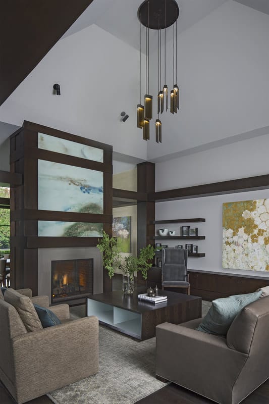 A double-sided fireplace adorned with multi-panel artwork is shared by the living and dining rooms.A double-sided fireplace adorned with multi-panel artwork is shared by the living and dining rooms.