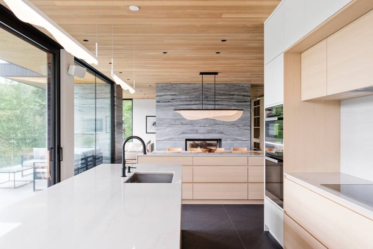 Floor-to-ceiling windows bring natural light into the kitchen.