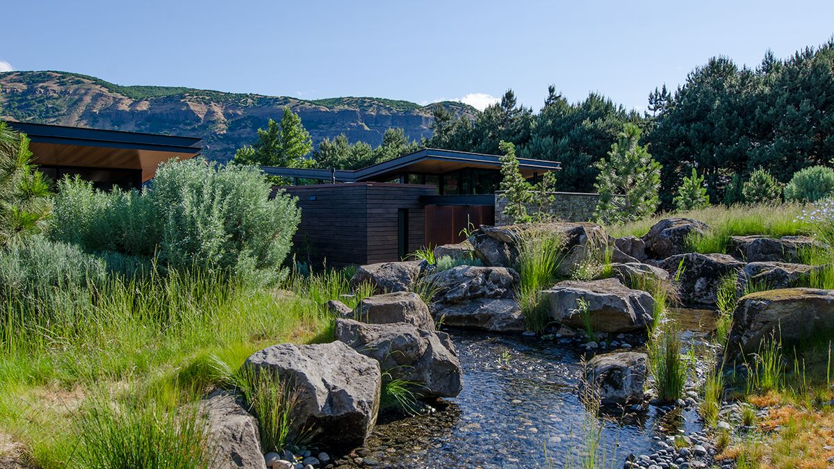 This waterfront home is simplistic and has a natural appearance that can be appealing due to the waterside.