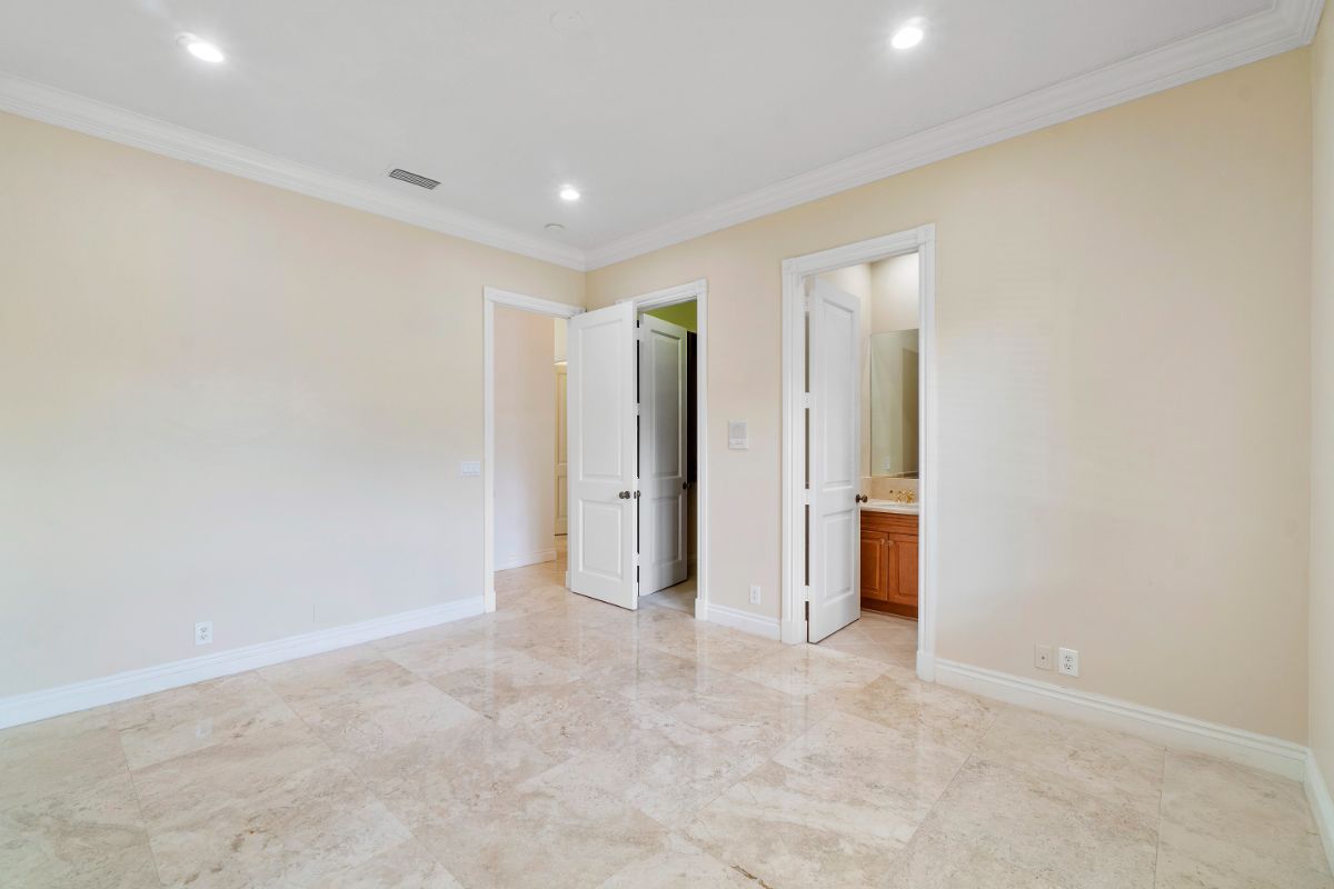 The bedroom spaces feature tile flooring and a bathroom.