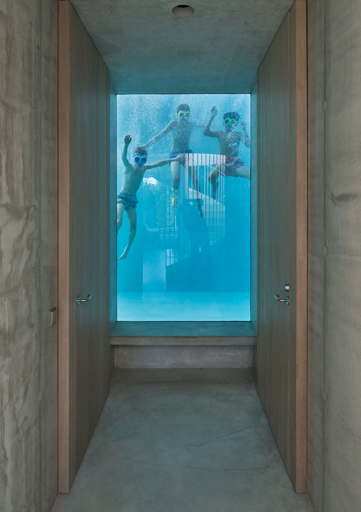 The indoor swimming pool is enclosed with glass walls and can be seen on the ground floor.