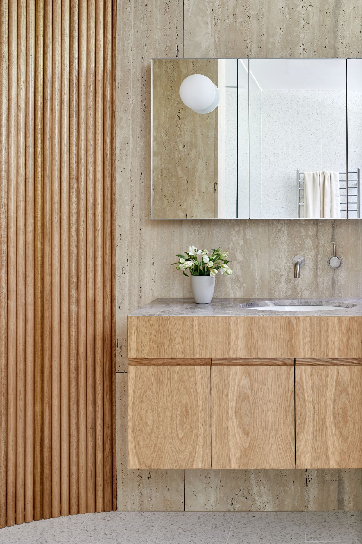 The bathroom features a floating vanity with a marble countertop.