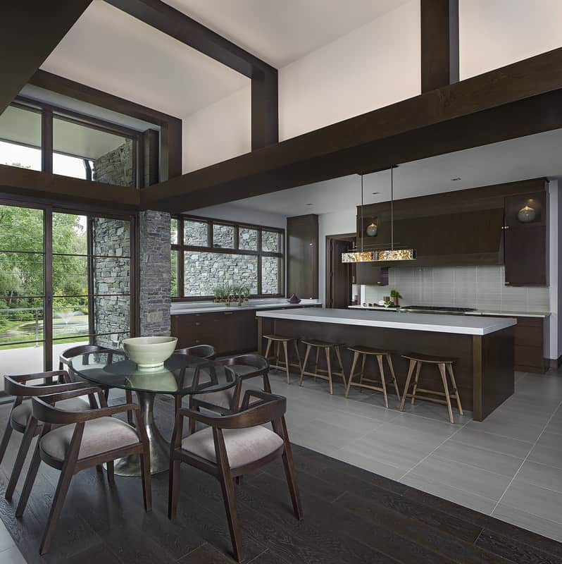 Dark wood elements are echoed in the eat-in kitchen to maintain a cohesive look.