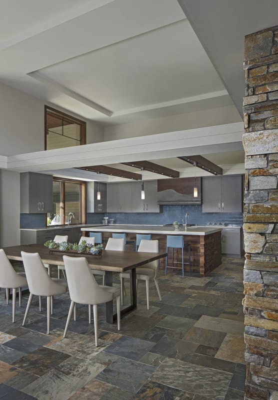 The dining area also opens to the kitchen defined by exposed beams.