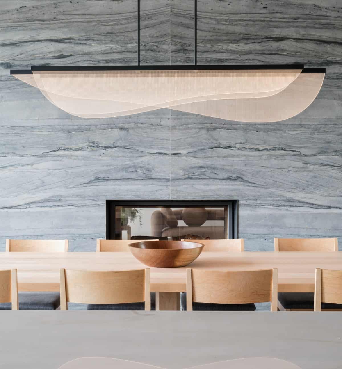 A unique contemporary chandelier illuminates the dining area.