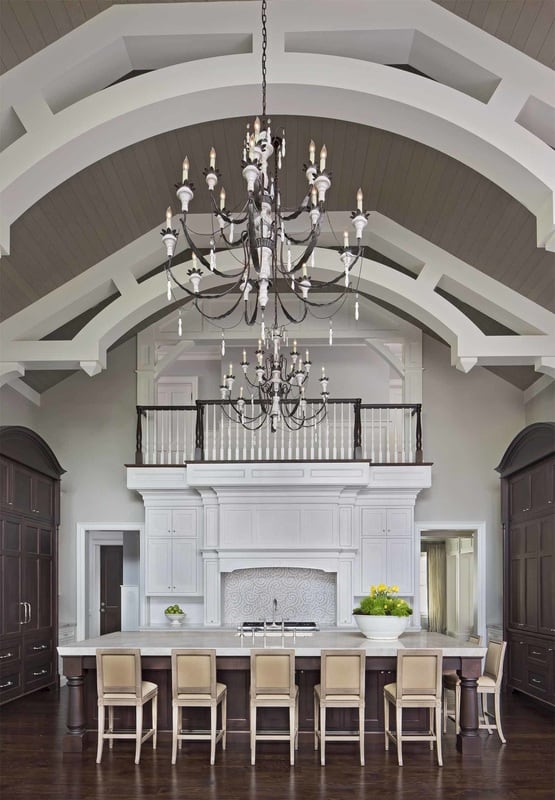 A soaring vaulted ceiling accentuated with exposed trusses crowns the kitchen.