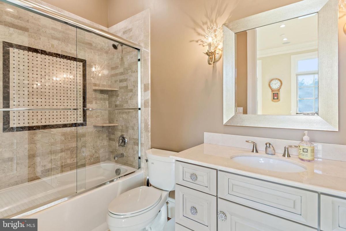 The bedroom's bathroom features a bathroom and a vanity.