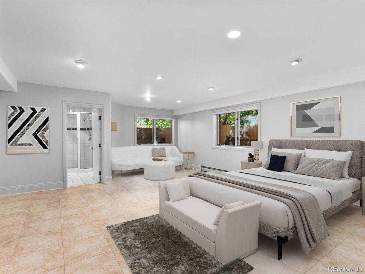 The bedroom features a bedroom bench and a lounge giving off a cozy feel.