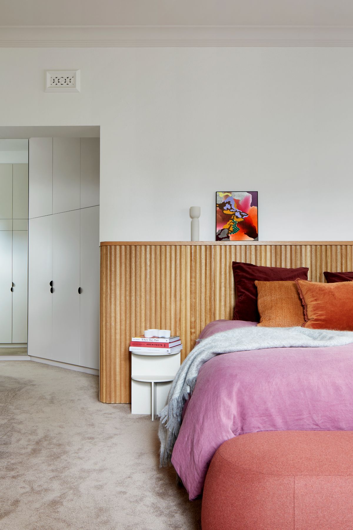 Master bedroom with headboard created with Tasmanian oak wood dowels for a highly finished art deco minimalist feel.