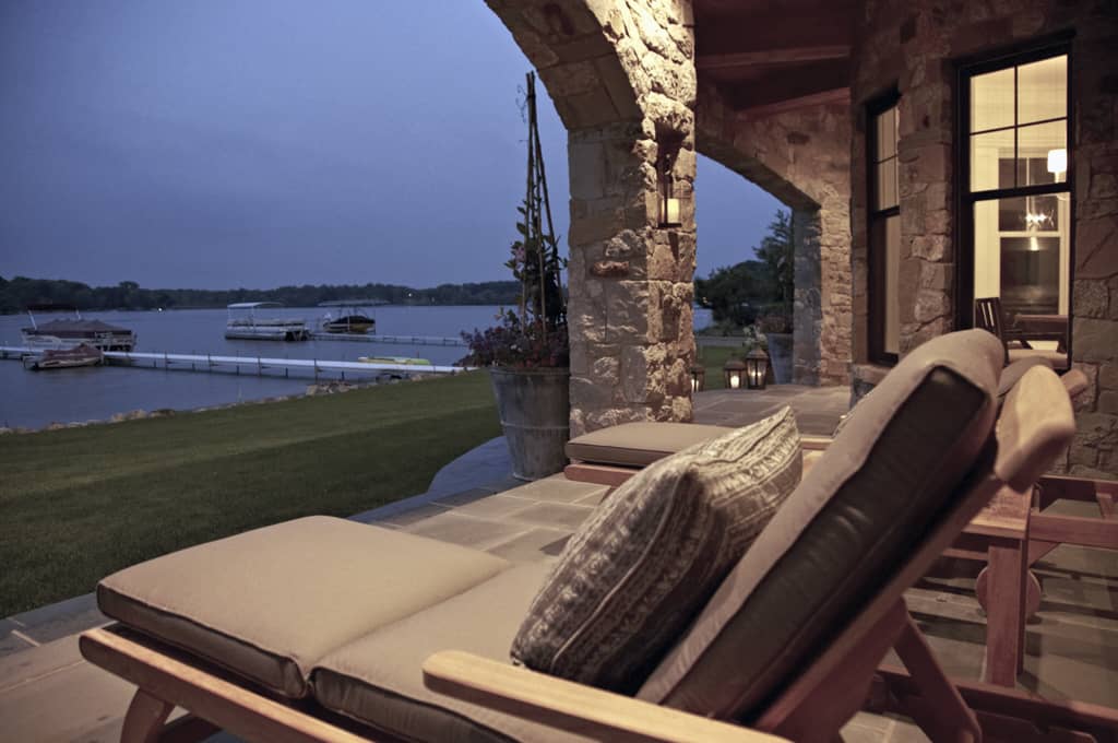 The covered porch offers cushioned loungers perfect for relaxing and enjoying the views.