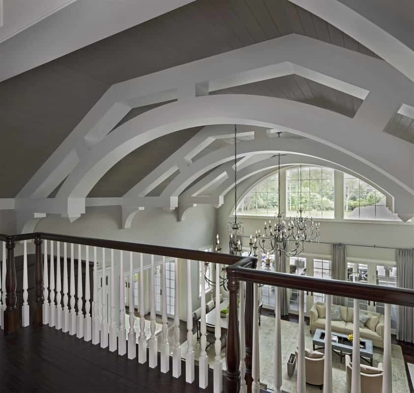 The kitchen's vaulted ceiling spans through the second-level balcony.