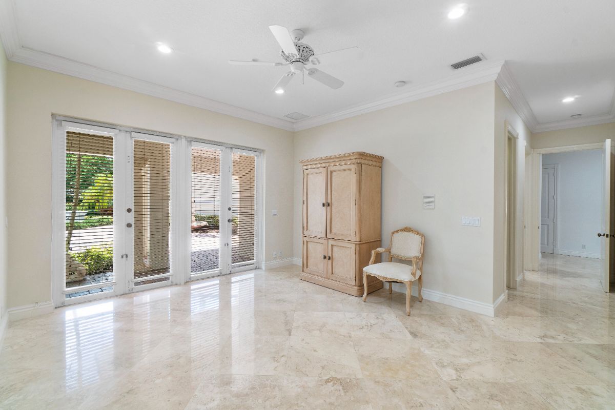 The bedroom space features a wooden cabinet and access to the backyard.