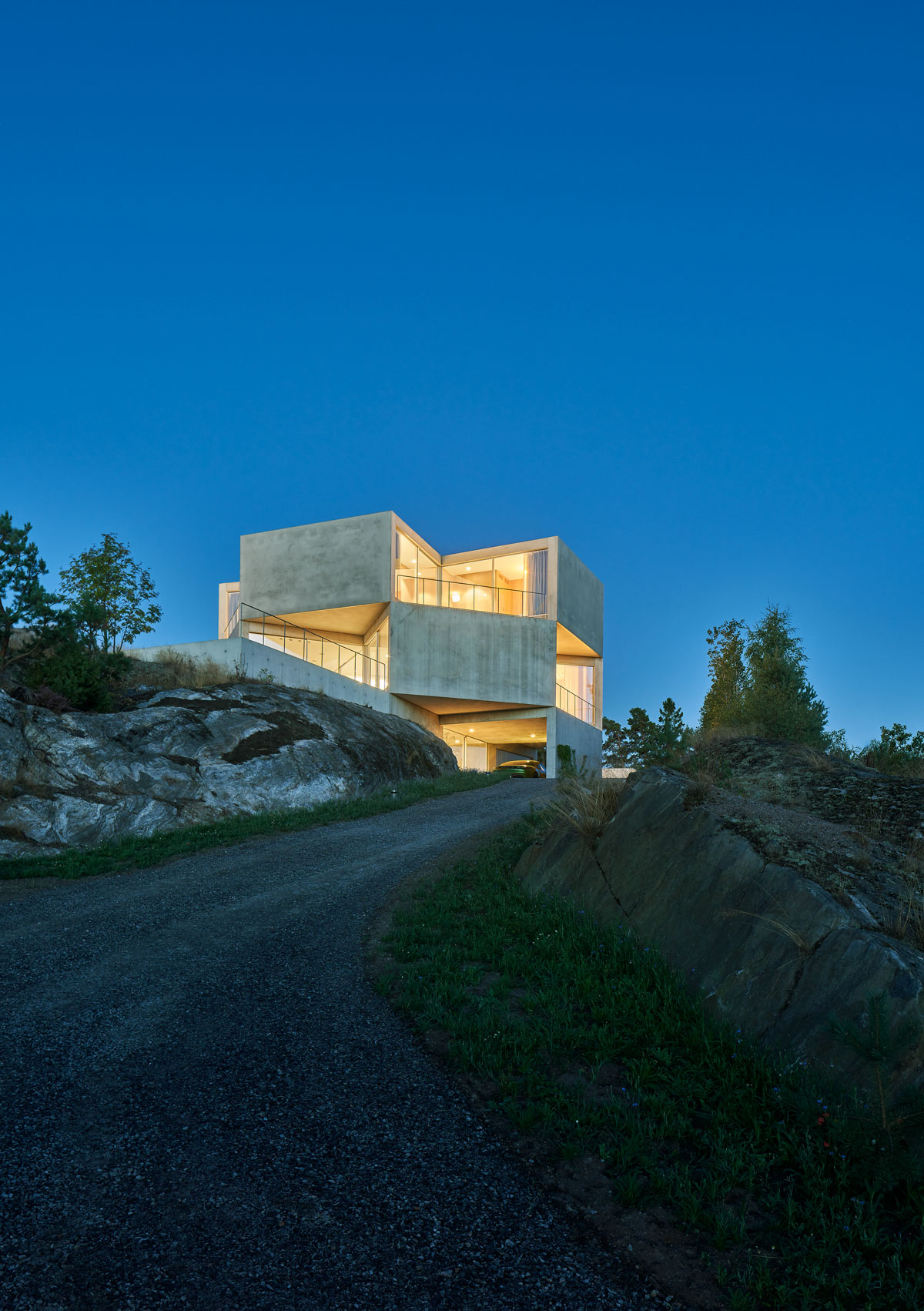 The driveway to the house is made of gravel that blends well with the natural bedrock surrounding the place