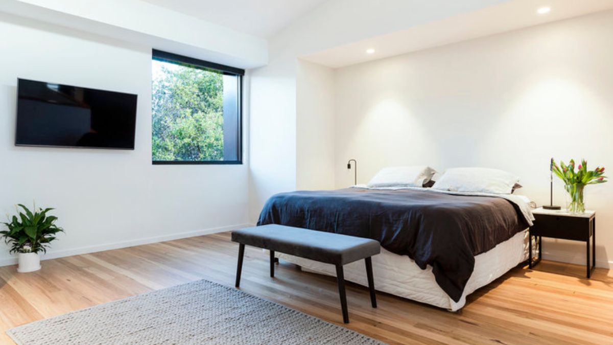 An angle of the bedroom captures the glass window.