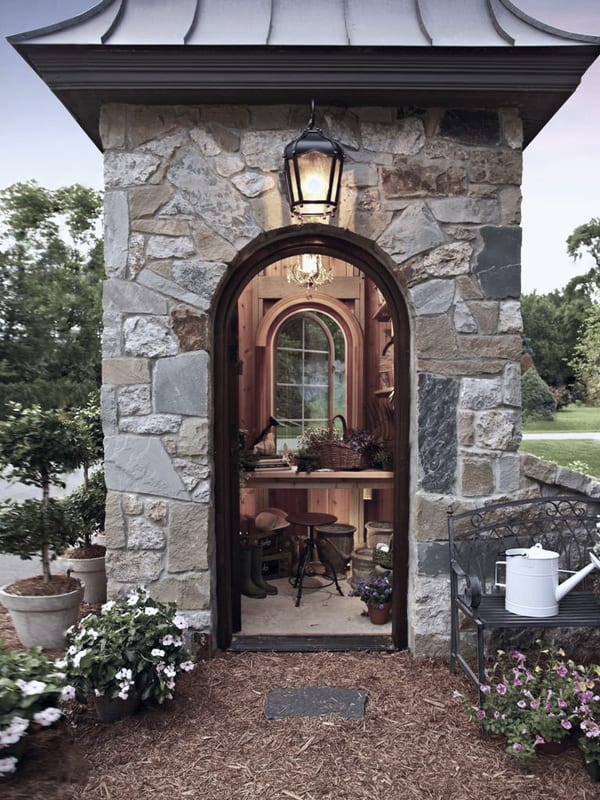 The home also features a storage shed with a stone exterior and an arched door.