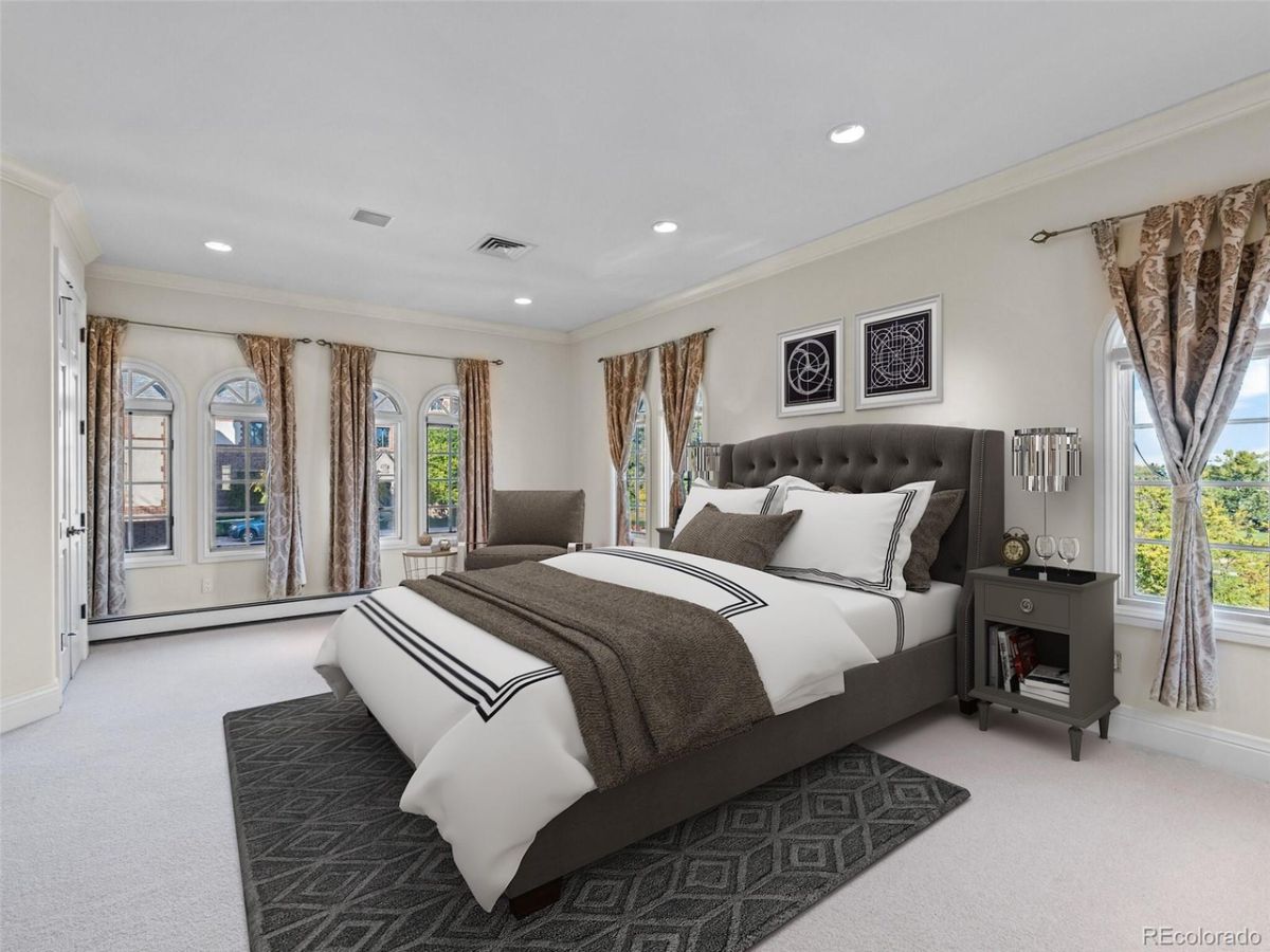 The master suite features a king-size bed with curtains to regulate sunlight.