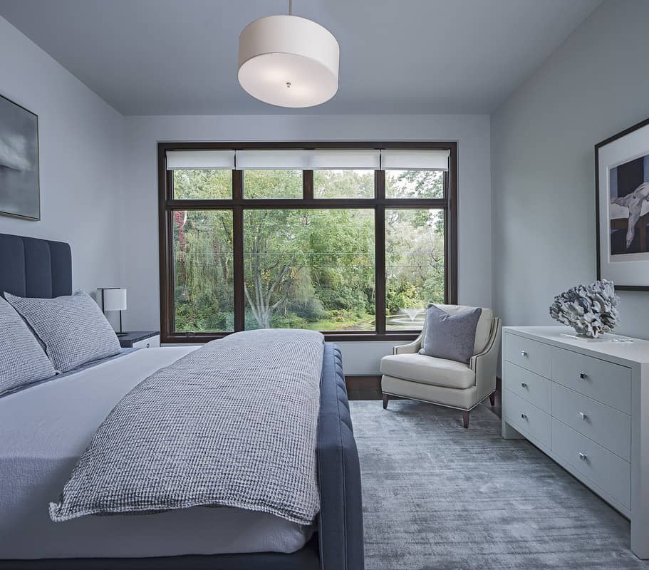 This bedroom features a gray palette with dark wood accents.