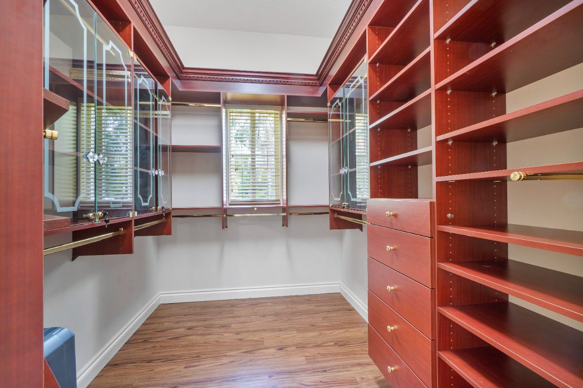 The master suite features a dresser, and the gold-plated handles of the cabinet give the room a luxurious feel.