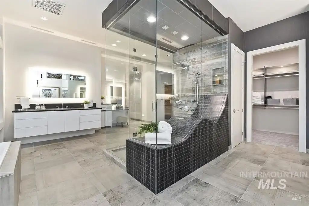 The bathroom features a shower cubicle and a floating vanity.