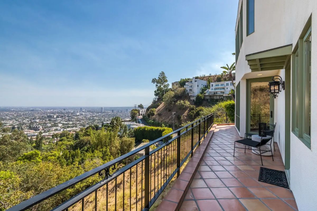 The balcony offers a perfect place for relaxation with a view of the city.