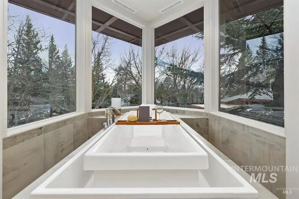 The bathtub features glass walls to showcase the surroundings while taking a dip.