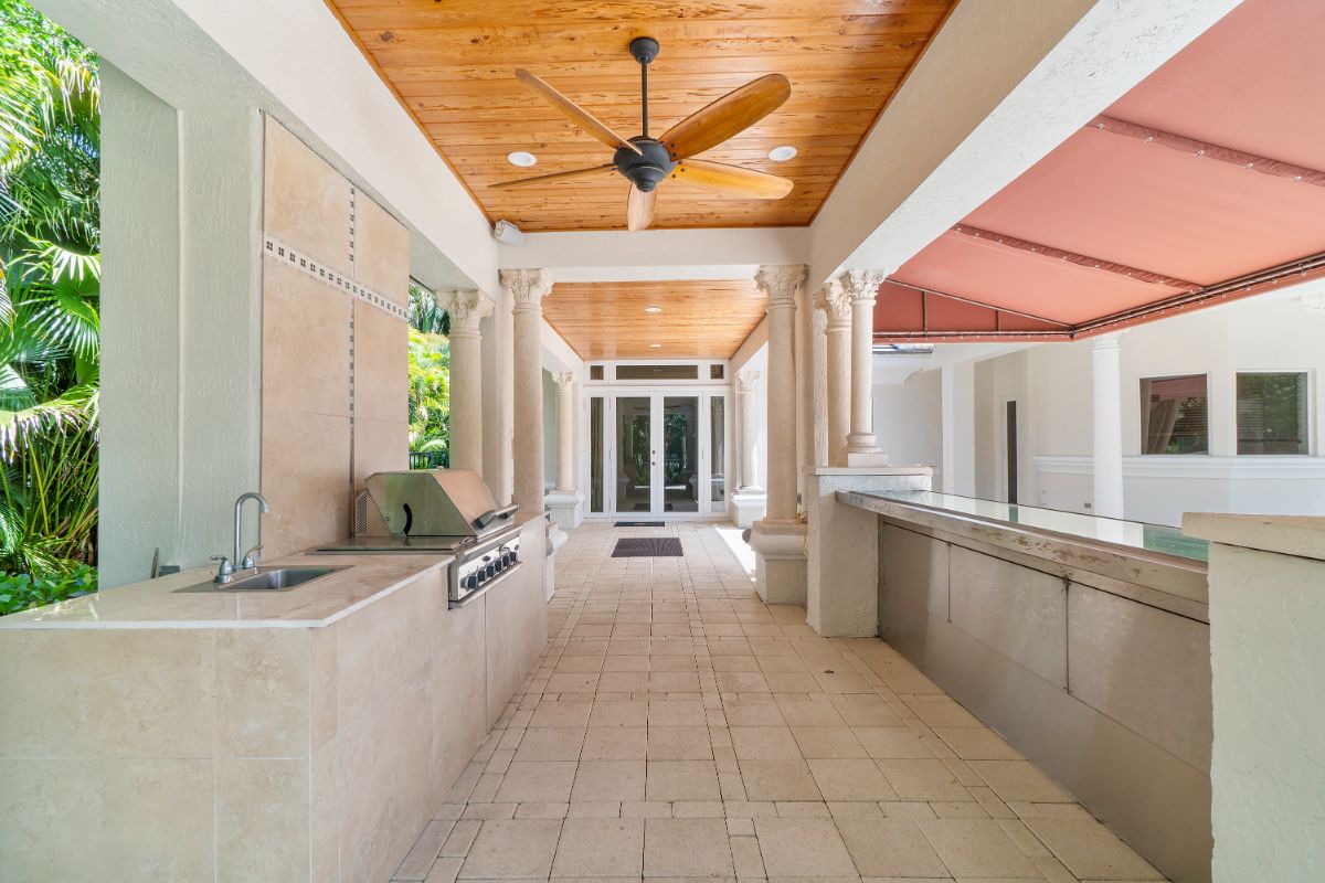 The outdoor kitchen features a counter that can be used as an outdoor bar.