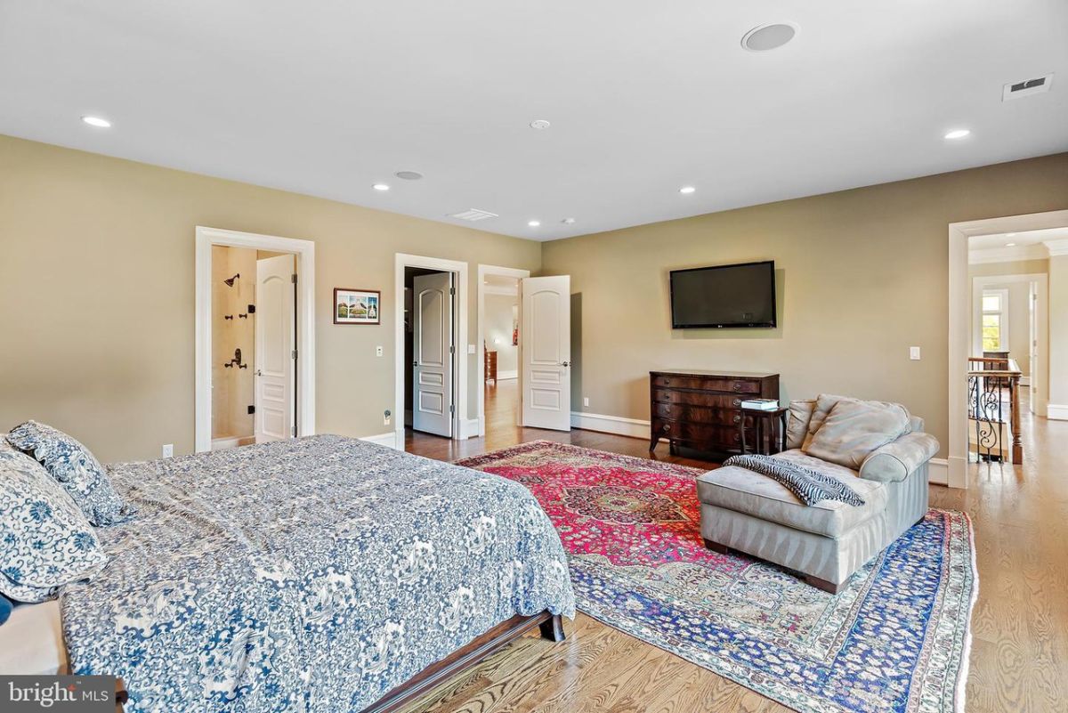 The guest room features a carpet and a chaise giving the room a cozy feel.